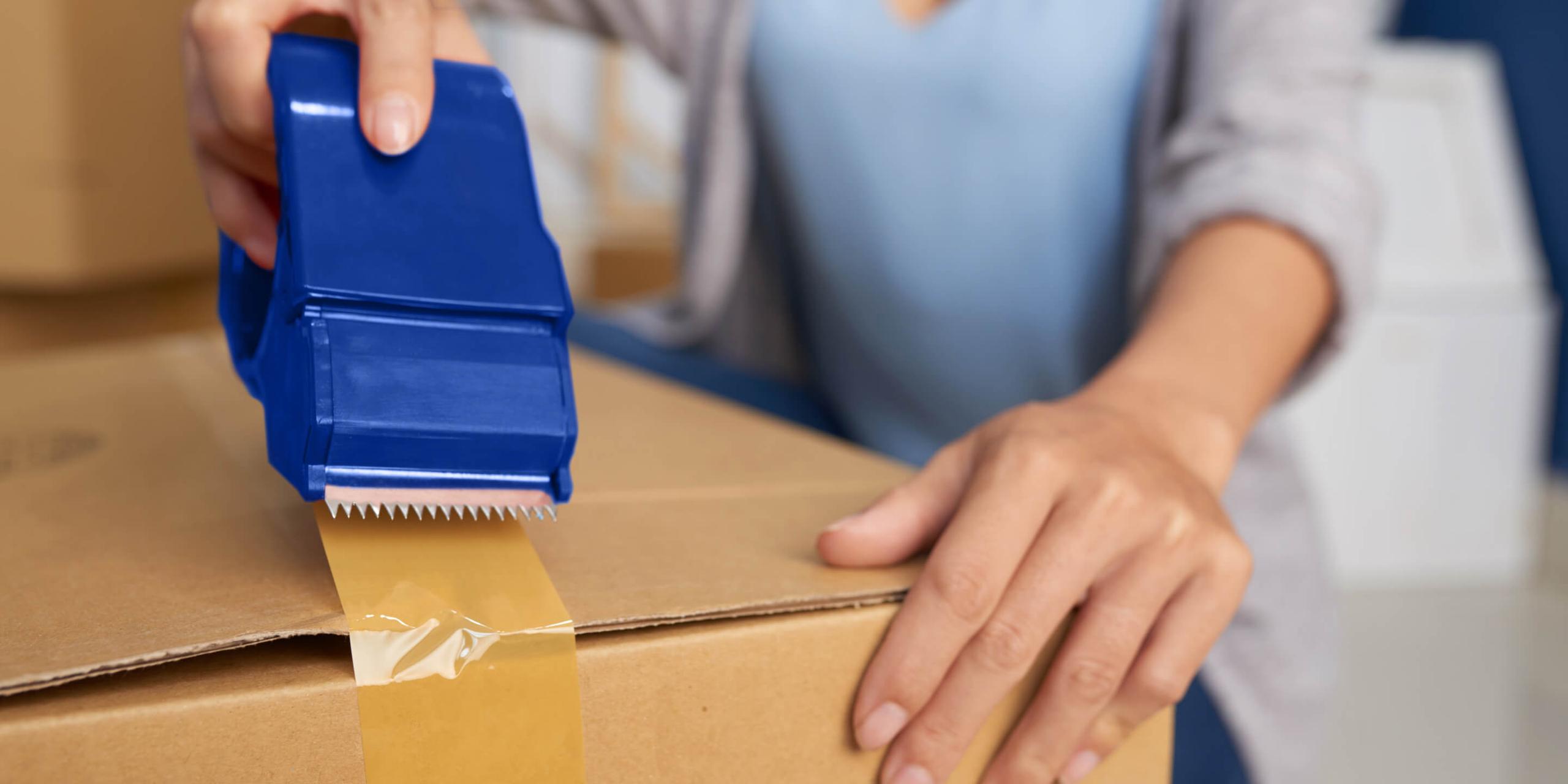 A family packing boxes with a moving checklist on a clipboard